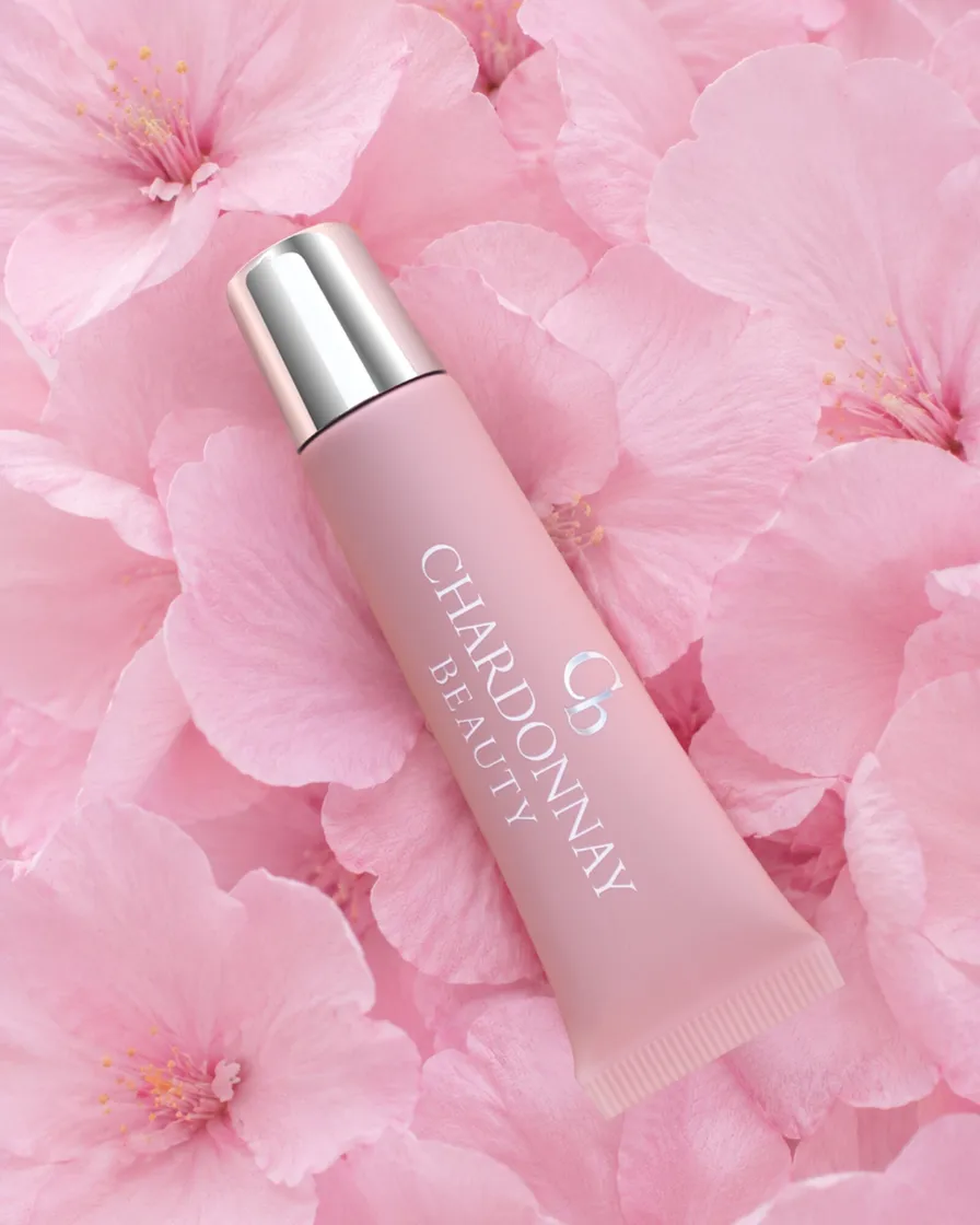 A Chardonnay Beauty tube lying on pink blossoms